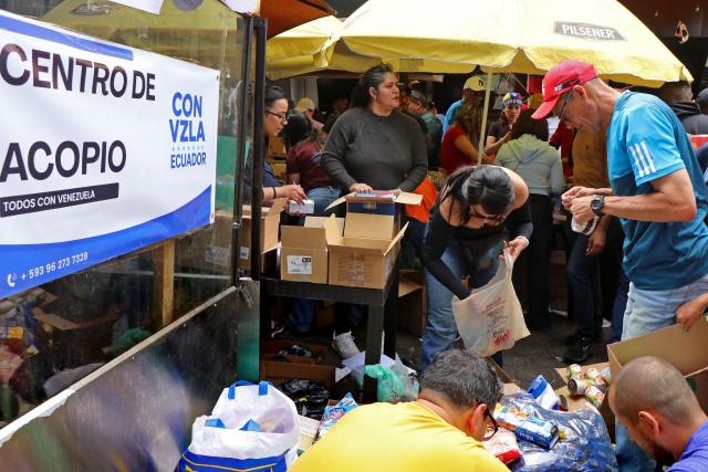 Venezuelans living in Ecuador gather supplies for the victims of the twin earthquakes in their homeland, at an improvised collection centre in northern Quito, on June 27, 2026. The death toll in Venezuela's twin earthquake disaster reached 1,430, and millions more were feared to lack sanitation and other basic needs as the first US aid flights trickled into Caracas. (Photo by Galo Paguay / AFP)