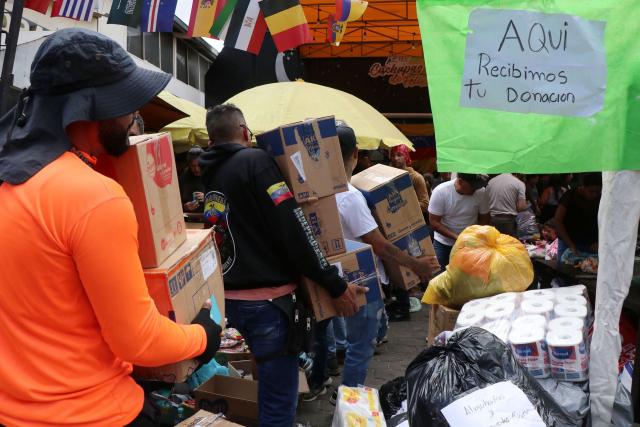 Venezuelans living in Ecuador gather supplies for the victims of the twin earthquakes in their homeland, at an improvised collection centre in northern Quito, on June 27, 2026. The death toll in Venezuela's twin earthquake disaster reached 1,430, and millions more were feared to lack sanitation and other basic needs as the first US aid flights trickled into Caracas. (Photo by Galo Paguay / AFP)
