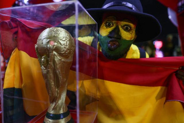 A Ghanaian football supporter poses with a makeshift World Cup trophy as he waits for the start of the 2026 FIFA World Cup match between Ghana and Croatia in Accra on June 27, 2026. (Photo by Nipah Dennis / AFP)
