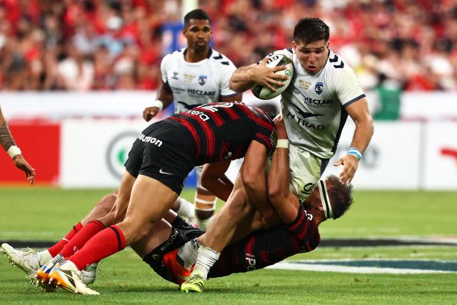 Montpellier’s Argentinian centre Justo Piccardo is tackled by Toulouse's French number eight Alexandre Roumat (down) during the French Top 14 rugby union final between Stade Toulousain (Toulouse) and Montpellier Hйrault Rugby (MHR) at the Stade de France in Saint-Denis, on the outskirts of Paris, on June 27, 2026. (Photo by Anne-Christine POUJOULAT / AFP)