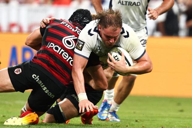 Montpellier’s French flanker Lenni Nouchi is tackled during the French Top 14 rugby union final between Stade Toulousain (Toulouse) and Montpellier Hйrault Rugby (MHR) at the Stade de France in Saint-Denis, on the outskirts of Paris, on June 27, 2026. (Photo by Anne-Christine POUJOULAT / AFP)