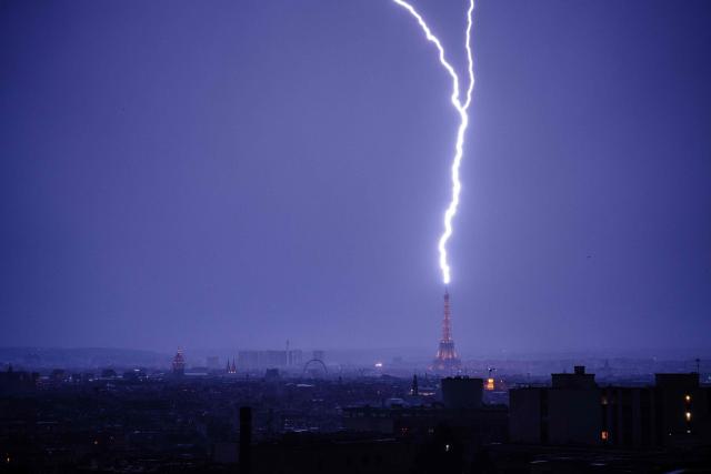 Lightning strikes the Eiffel Tower during a thunderstorm in Paris on June 27, 2026. (Photo by DIMITAR DILKOFF / AFP)