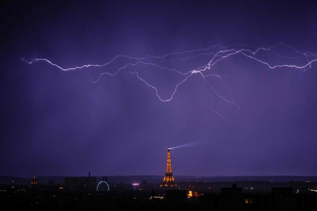 Lightning strikes over the Eiffel Tower during a thunderstorm in Paris on June 27, 2026. (Photo by DIMITAR DILKOFF / AFP)