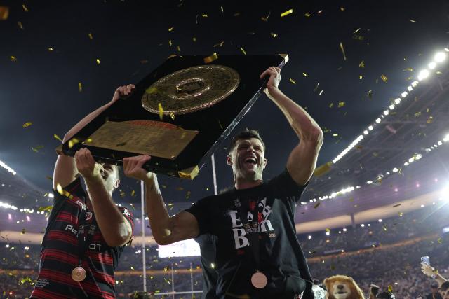 Toulouse's Scottish full back Blair Kinghorn (R) celebrates with the "Bouclier de Brennus" trophy after winning the French Top 14 rugby union final against Montpellier Hérault Rugby (MHR) at the Stade de France in Saint-Denis, on the outskirts of Paris, on June 27, 2026. (Photo by Kenzo TRIBOUILLARD / AFP)
