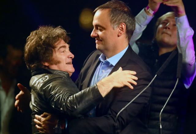 (FILES) Argentina's President Javier Milei (L) embraces Presidency Spokesman and legislative candidate Manuel Adorni during his closing campaign rally in Buenos Aires on May 14, 2025. Adorni, who earlier this month confessed he had concealed 500,000 US dollars in his sworn statements, sparking an uproar and criticism from figures in the opposition and from within the government itself, presented his resignation on June 27, 2026 in Buenos Aires. (Photo by AFP)