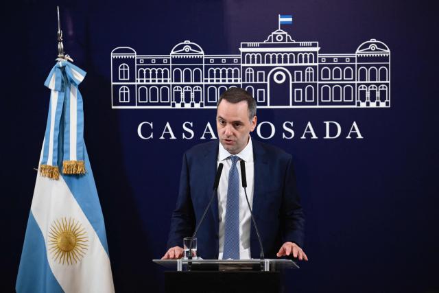 (FILES) Argentina's presidential spokesman Manuel Adorni delivers a press conference at Casa Rosada presidential palace in Buenos Aires on December 11, 2023. Adorni, who earlier this month confessed he had concealed 500,000 US dollars in his sworn statements, sparking an uproar and criticism from figures in the opposition and from within the government itself, presented his resignation on June 27, 2026 in Buenos Aires. (Photo by Luis ROBAYO / AFP)