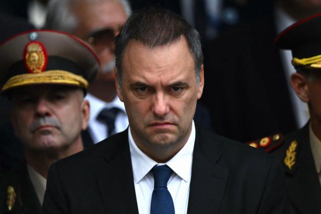 (FILES) Argentina's Chief of Cabinet Manuel Adorni attends a ceremony to commemorate the 44th anniversary of the war between Argentina and the United Kingdom over the Falkland Islands (called Las Malvinas by Argentina) at the 'Cenotaph to the Fallen of the Malvinas War' in Buenos Aires on April 2, 2026. Adorni, who earlier this month confessed he had concealed 500,000 US dollars in his sworn statements, sparking an uproar and criticism from figures in the opposition and from within the government itself, presented his resignation on June 27, 2026 in Buenos Aires. (Photo by Luis ROBAYO / AFP)