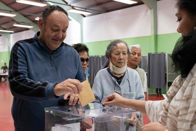 People cast their vote at the polling station at the Salle Jean-Noyant during the provincial elections in the Motor Pool neighborhood of Noumea, New Caledonia, on June 28, 2026. (Photo by Delphine MAYEUR / AFP)
