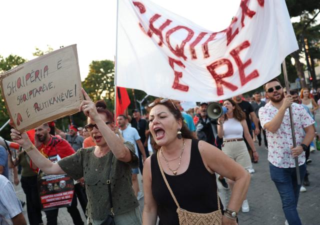 People demonstrate holding placards and banners in front of Albania's Prime Minister's office against a planned resort linked to US President's family, in Tirana on June 27, 2026. Since late May, protesters have gathered every evening to oppose the construction of a luxury hotel linked to Trump's daughter Ivanka and her husband Jared Kushner, planned in a nature reserve on the Balkan nation's coast. (Photo by Adnan Beci / AFP)