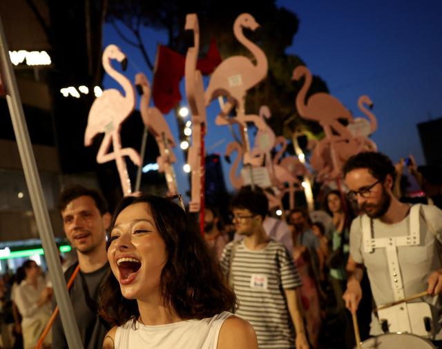 People demonstrate holding flamingo cutouts in front of Albania's Prime Minister's office against a planned resort linked to US President's family, in Tirana on June 27, 2026. Since late May, protesters have gathered every evening to oppose the construction of a luxury hotel linked to Trump's daughter Ivanka and her husband Jared Kushner, planned in a nature reserve on the Balkan nation's coast. (Photo by Adnan Beci / AFP)