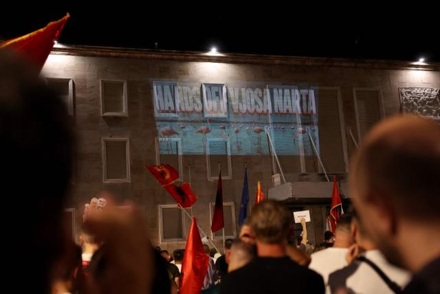 A image of flamingos is projected onto the wall of Albania's Prime Minister's office during a demonstration against a planned resort linked to US President's family, in Tirana on June 27, 2026. Since late May, protesters have gathered every evening to oppose the construction of a luxury hotel linked to Trump's daughter Ivanka and her husband Jared Kushner, planned in a nature reserve on the Balkan nation's coast. (Photo by Adnan Beci / AFP)