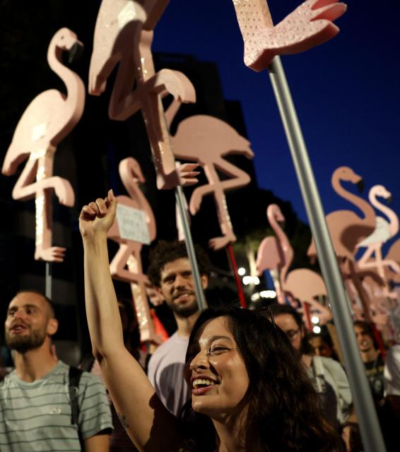 People demonstrate holding flamingo cutouts in front of Albania's Prime Minister's office against a planned resort linked to US President's family, in Tirana on June 27, 2026. Since late May, protesters have gathered every evening to oppose the construction of a luxury hotel linked to Trump's daughter Ivanka and her husband Jared Kushner, planned in a nature reserve on the Balkan nation's coast. (Photo by Adnan Beci / AFP)