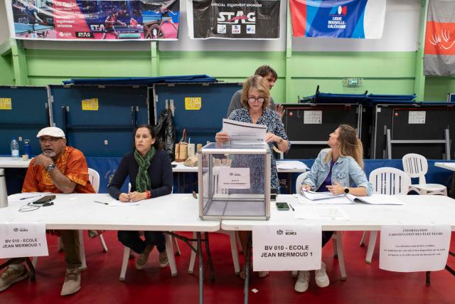 Election officials attend at the Jean-Noyant polling station in the Motor Pool neighborhood of Noumea in the French overseas territory of New Caledonia on June 28, 2026 during the archipelago's first provincial elections since 2019, after the vote was delayed three times as talks over the territory's political future stalled. The vote, initially planned for 2024, will determine the balance of power in New Caledonia ahead of fresh negotiations with France on the territory's future status. Three referendums on independence held in 2018, 2020 and 2021 returned majorities in favour of remaining part of France, although pro-independence groups boycotted the third vote, which was held during the Covid pandemic. (Photo by Delphine MAYEUR / AFP)
