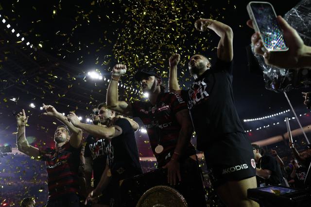 Stade Toulousain (Toulouse) players celebrate with the "Bouclier de Brennus" trophy after winning the French Top 14 rugby union final against Montpellier Hérault Rugby (MHR) at the Stade de France in Saint-Denis, on the outskirts of Paris, on June 27, 2026. (Photo by Anne-Christine POUJOULAT / AFP)