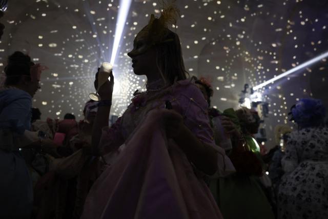 Attendees wearing period costumes take part in the 14th edition of The Grand Masked Ball clubbing event in the Orangerie of the Chateau de Versailles in Versailles, southwest of Paris, on June 27, 2026. (Photo by Charlotte SIEMON / AFP)