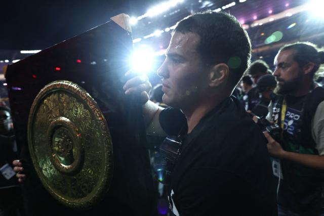 Toulouse's French scrum-half Antoine Dupont brings the "Bouclier de Brennus" trophy to supporters after winning the French Top 14 rugby union final against Montpellier Hérault Rugby (MHR) at the Stade de France in Saint-Denis, on the outskirts of Paris, on June 27, 2026. (Photo by Anne-Christine POUJOULAT / AFP)