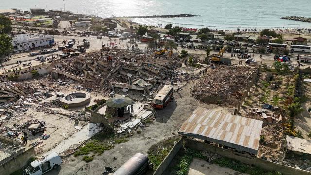 This aerial picture shows buildings destroyed during twin earthquakes, in Caraballeda, La Guaira State, Venezuela, on June 27, 2026. The death toll in Venezuela's June 24 twin earthquake disaster reached 1,430 on June 27, and millions more were feared to lack sanitation and other basic needs, as the first US aid flights landed in Caracas. (Photo by Miguel MEDINA / POOL / AFP)