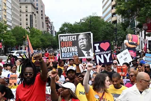 People march during a “Next250: A National Mobilization” rally in Washington, DC, on June 27, 2026. Activists are conducting a nationwide response to the planned events by the administration of US President Donald Trump to mark the 250th anniversary of the United States' Declaration of Independence. (Photo by Alex WROBLEWSKI / AFP)