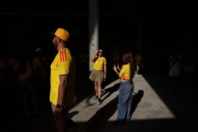 A Colombian fan takes a picture to another colombian fan ahead of the 2026 World Cup Group K football match between Colombia and Portugal at the Miami Stadium in Miami Gardens on June 27, 2026.  (Photo by PATRICIA DE MELO MOREIRA / AFP)