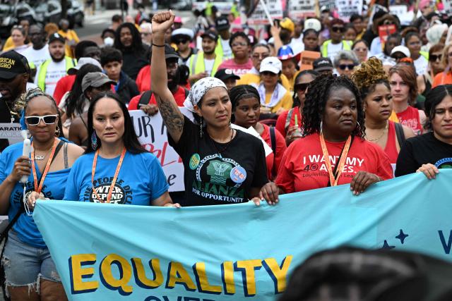 People march during a “Next250: A National Mobilization” rally in Washington, DC, on June 27, 2026. Activists are conducting a nationwide response to the planned events by the administration of US President Donald Trump to mark the 250th anniversary of the United States' Declaration of Independence. (Photo by Alex WROBLEWSKI / AFP)