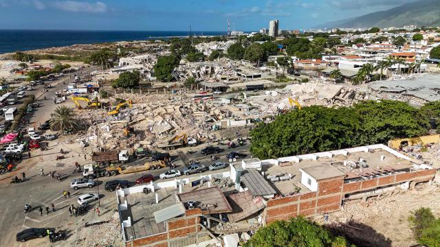 This aerial picture shows buildings destroyed during twin earthquakes, in Caraballeda, La Guaira State, Venezuela, on June 27, 2026. The death toll in Venezuela's June 24 twin earthquake disaster reached 1,430 on June 27, and millions more were feared to lack sanitation and other basic needs, as the first US aid flights landed in Caracas. (Photo by Miguel MEDINA / POOL / AFP)