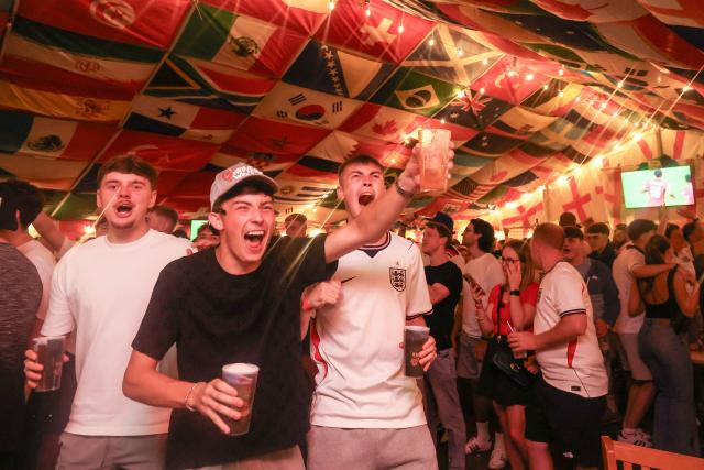 England supporters cheer after their team's first goal as they watch the television broadcast of the 2026 World Cup Group L football match between England and Panama, at The Clock pub in Hebburn, north-east England late on June 27, 2026. (Photo by SCOTT HEPPELL / AFP)