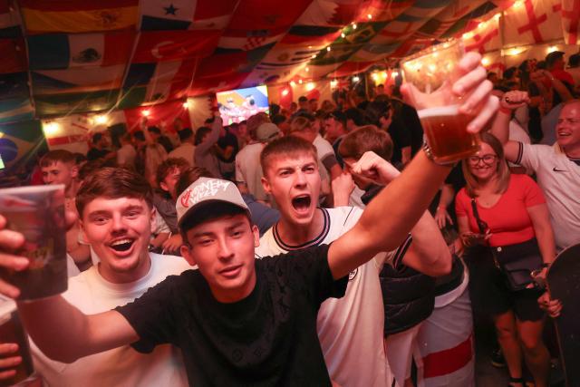 England supporters cheer after their team's first goal as they watch the television broadcast of the 2026 World Cup Group L football match between England and Panama, at The Clock pub in Hebburn, north-east England late on June 27, 2026. (Photo by SCOTT HEPPELL / AFP)