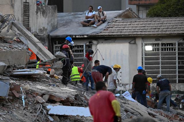 Volunteers search for possible victims at a collapsed building following twin earthquakes, in San Bernardino neighbourhood, in Caracas on June 27, 2026. The death toll in Venezuela's June 24 twin earthquake disaster reached 1,430, and millions more were feared to lack sanitation and other basic needs, as the first US aid flights landed in Caracas. (Photo by Juan BARRETO / AFP)