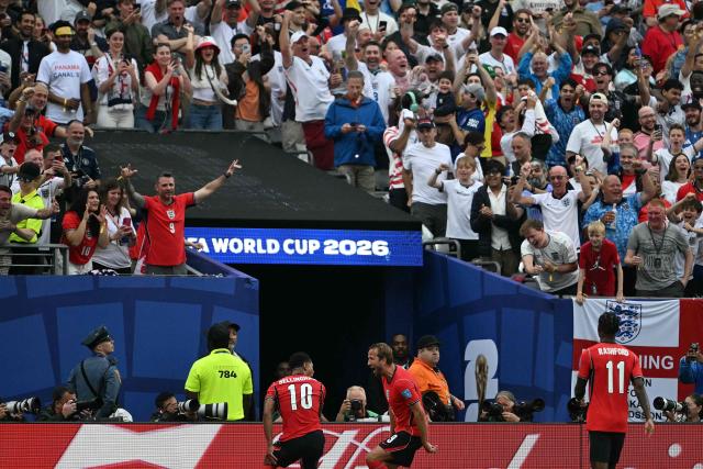 England's forward #09 Harry Kane (C) celebrates scoring his team's second goal with teammate midfielder #10 Jude Bellingham during the 2026 World Cup Group L football match between Panama and England at the New York/New Jersey Stadium in East Rutherford on June 27, 2026.  (Photo by MAURO PIMENTEL / AFP)