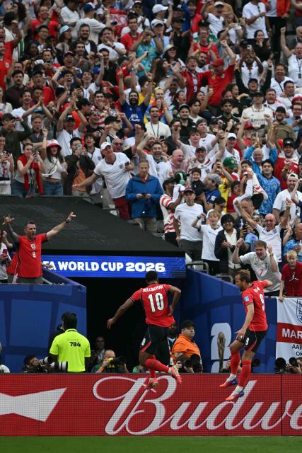 England's forward #09 Harry Kane (R) celebrates scoring his team's second goal with teammate midfielder #10 Jude Bellingham during the 2026 World Cup Group L football match between Panama and England at the New York/New Jersey Stadium in East Rutherford on June 27, 2026.  (Photo by MAURO PIMENTEL / AFP)
