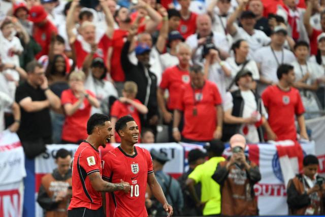England's midfielder #10 Jude Bellingham celebrates scoring his team's first goal with teammate midfielder #17 Morgan Rogers during the 2026 World Cup Group L football match between Panama and England at the New York/New Jersey Stadium in East Rutherford on June 27, 2026.  (Photo by MAURO PIMENTEL / AFP)