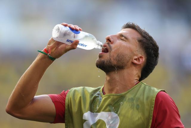 Portugal's defender #03 Ruben Dias drinks water as he warms up ahead of the 2026 World Cup Group K football match between Colombia and Portugal at the Miami Stadium in Miami Gardens on June 27, 2026.  (Photo by PATRICIA DE MELO MOREIRA / AFP)
