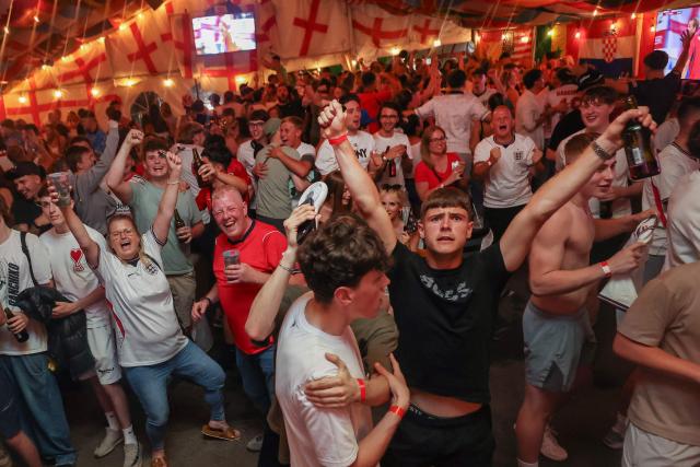 England supporters cheer after their team's second goal as they watch the television broadcast of the 2026 World Cup Group L football match between England and Panama, at The Clock pub in Hebburn, north-east England late on June 27, 2026. (Photo by SCOTT HEPPELL / AFP)