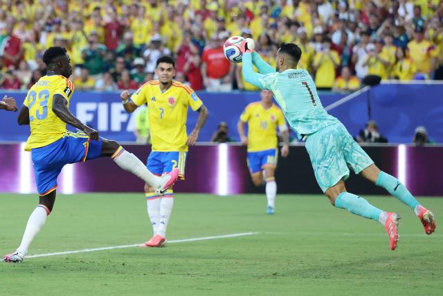 Portugal's goalkeeper #01 Diogo Costa makes a save past Colombia's defender #23 Davinson Sanchez and forward #07 Luis Diaz during the 2026 World Cup Group K football match between Colombia and Portugal at the Miami Stadium in Miami Gardens on June 27, 2026.  (Photo by PATRICIA DE MELO MOREIRA / AFP)