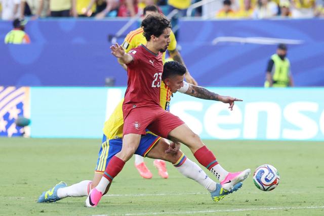 Portugal's midfielder #23 Vitinha and Colombia's midfielder #10 James Rodriguez fight for the ball during the 2026 World Cup Group K football match between Colombia and Portugal at the Miami Stadium in Miami Gardens on June 27, 2026.  (Photo by PATRICIA DE MELO MOREIRA / AFP)