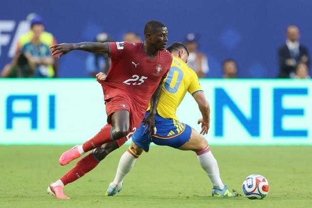 Portugal's defender #25 Nuno Mendes and Colombia's midfielder #10 James Rodriguez fight for the ball during the 2026 World Cup Group K football match between Colombia and Portugal at the Miami Stadium in Miami Gardens on June 27, 2026.  (Photo by PATRICIA DE MELO MOREIRA / AFP)