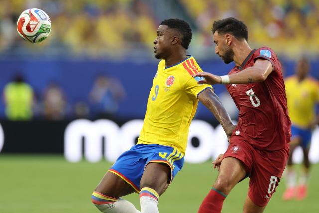Colombia's forward #09 Jhon Cordoba and Portugal's midfielder #08 Bruno Fernandes fight for the ball during the 2026 World Cup Group K football match between Colombia and Portugal at the Miami Stadium in Miami Gardens on June 27, 2026.  (Photo by PATRICIA DE MELO MOREIRA / AFP)