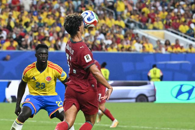 Portugal's forward #11 Joao Felix controls the ball past Colombia's defender #23 Davinson Sanchez during the 2026 World Cup Group K football match between Colombia and Portugal at the Miami Stadium in Miami Gardens on June 27, 2026.  (Photo by CHANDAN KHANNA / AFP)