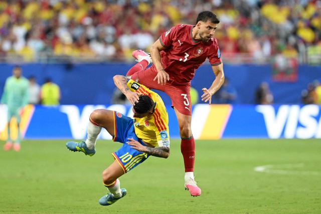 Portugal's defender #03 Ruben Dias fouls Colombia's midfielder #10 James Rodriguez during the 2026 World Cup Group K football match between Colombia and Portugal at the Miami Stadium in Miami Gardens on June 27, 2026.  (Photo by ROBERTO SCHMIDT / AFP)