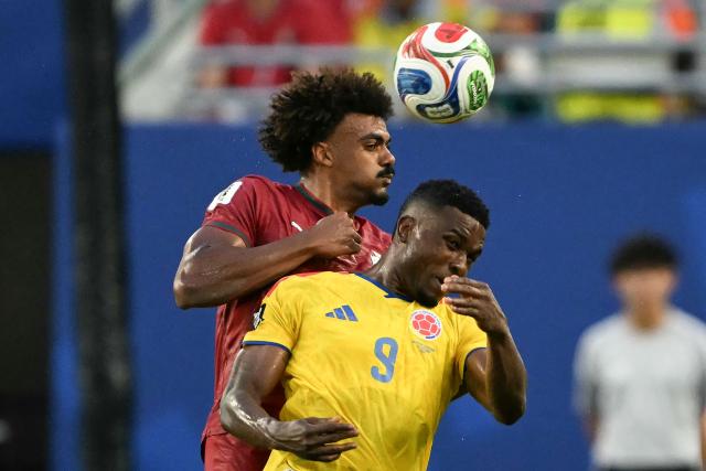Portugal's midfielder #13 Renato Veiga (L) and Colombia's forward #09 Jhon Cordoba (R) fight for the ball during the 2026 World Cup Group K football match between Colombia and Portugal at the Miami Stadium in Miami Gardens on June 27, 2026.  (Photo by CHANDAN KHANNA / AFP)
