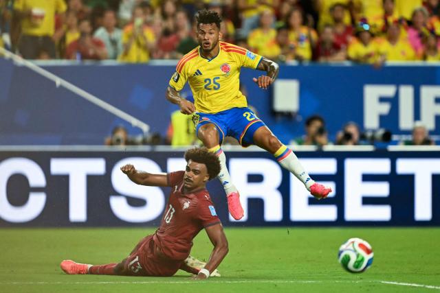 Portugal's midfielder #13 Renato Veiga and Colombia's forward #25 Luis Suarez look at the ball during the 2026 World Cup Group K football match between Colombia and Portugal at the Miami Stadium in Miami Gardens on June 27, 2026.  (Photo by CHANDAN KHANNA / AFP)