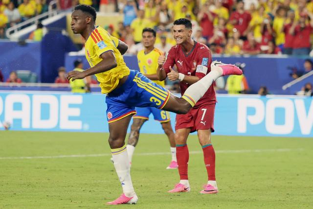 Portugal's forward #07 Cristiano Ronaldo reacts past Colombia's defender #03 Jhon Lucumi during the 2026 World Cup Group K football match between Colombia and Portugal at the Miami Stadium in Miami Gardens on June 27, 2026.  (Photo by PATRICIA DE MELO MOREIRA / AFP)