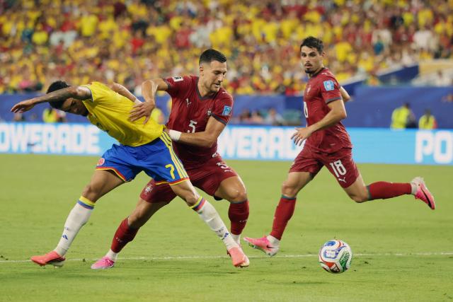 Colombia's forward #07 Luis Diaz and Portugal's defender #05 Diogo Dalot fight for the ball during the 2026 World Cup Group K football match between Colombia and Portugal at the Miami Stadium in Miami Gardens on June 27, 2026.  (Photo by PATRICIA DE MELO MOREIRA / AFP)