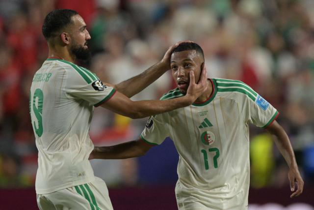 Algeria's defender #17 Rafik Belghali celebrates with Algeria's midfielder #19 Nabil Bentaleb after scoring his team's first goal during the 2026 World Cup Group J football match between Algeria and Austria at the Kansas City Stadium in Kansas City on June 27, 2026.  (Photo by JUAN MABROMATA / AFP)