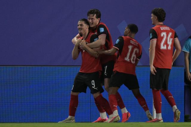 Austria's midfielder #09 Marcel Sabitzer (L) celebrates with teammates after scoring his team's second goal during the 2026 World Cup Group J football match between Algeria and Austria at the Kansas City Stadium in Kansas City on June 27, 2026.  (Photo by JUAN MABROMATA / AFP)