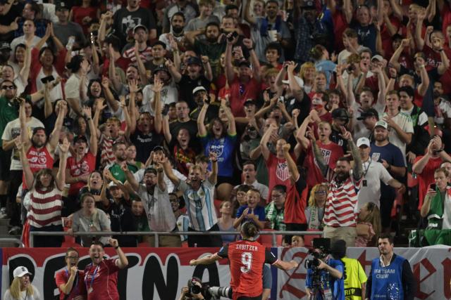 Fans react as Austria's midfielder #09 Marcel Sabitzer celebrates after scoring his team's second goal during the 2026 World Cup Group J football match between Algeria and Austria at the Kansas City Stadium in Kansas City on June 27, 2026.  (Photo by JUAN MABROMATA / AFP)