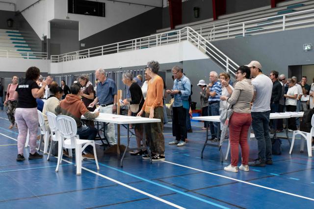 People cast their vote at the Salle Omnisports polling station in Noumea's Anse Vata district during provincial elections, in Noumea, New Caledonia, on June 28, 2026. (Photo by Delphine MAYEUR / AFP)