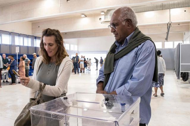 Walles Kotra, lead candidate of the "Une Province Pour Tous, Un Pays Solidaire, Un Avenir Partage" list, casts his ballot at the Veyret-Kafoa polling station during New Caledonia's provincial elections in the Riviere Salee neighbourhood of Noumea, New Caledonia, on June 28, 2026. (Photo by Delphine MAYEUR / AFP)