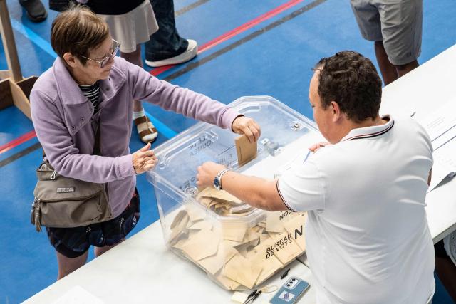 People cast their vote at the Salle Omnisports polling station in Noumea's Anse Vata district during provincial elections, in Noumea, New Caledonia, on June 28, 2026. (Photo by Delphine MAYEUR / AFP)