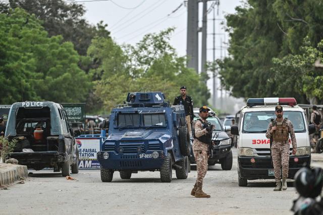 Security personnel stand guard at the end of a clearance operation following an alleged explosion and a militant attack in Karachi on June 28, 2026. Heavy gunfire was heard in Pakistan's southern megacity Karachi on June 27 evening, AFP journalists said, following reports of an explosion. (Photo by Asif HASSAN / AFP)